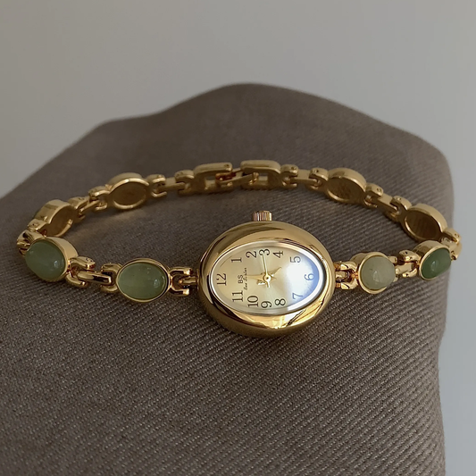 oval dial gold watch jade