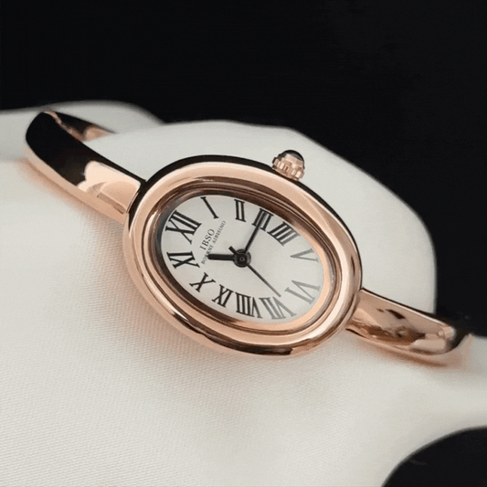 rose gold oval watch with white dial  